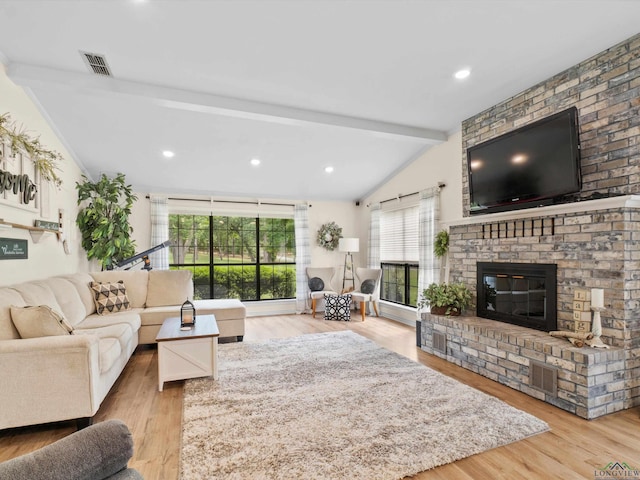 living area featuring visible vents, wood finished floors, a fireplace, recessed lighting, and lofted ceiling with beams