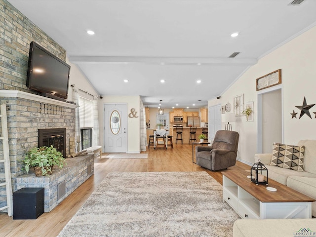 living area featuring a brick fireplace, recessed lighting, baseboards, vaulted ceiling with beams, and light wood-type flooring