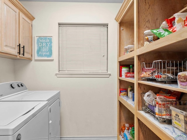 washroom featuring cabinet space and independent washer and dryer