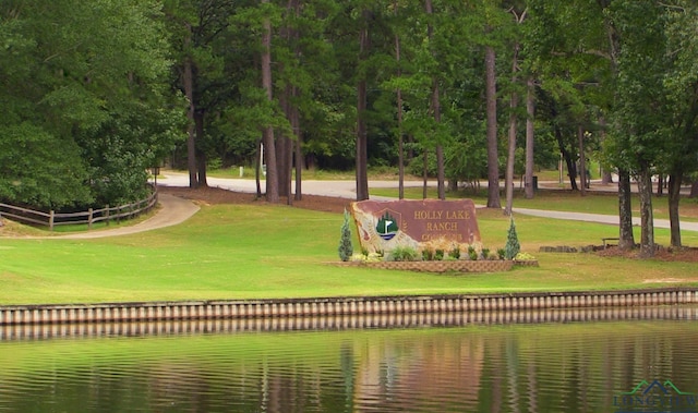 view of community featuring a water view and a yard