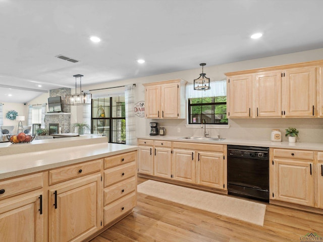 kitchen with a notable chandelier, a sink, light brown cabinets, light countertops, and black dishwasher
