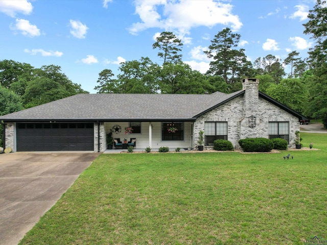 view of front of home with a garage, driveway, roof with shingles, and a front yard