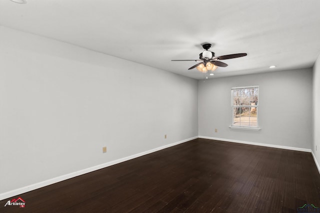 empty room featuring ceiling fan and dark hardwood / wood-style floors