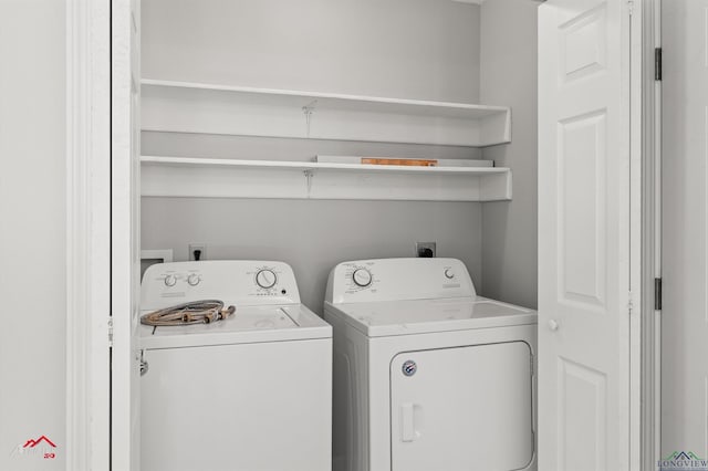 washroom featuring washer and clothes dryer