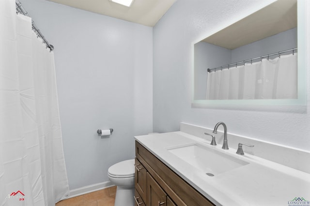 bathroom with tile patterned floors, vanity, and toilet