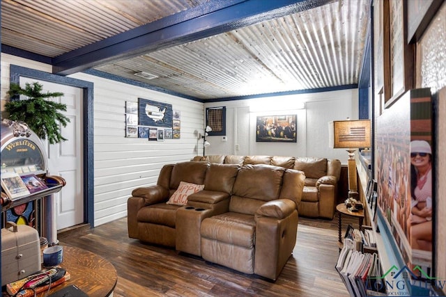 living room featuring wood finished floors, wooden walls, and beamed ceiling