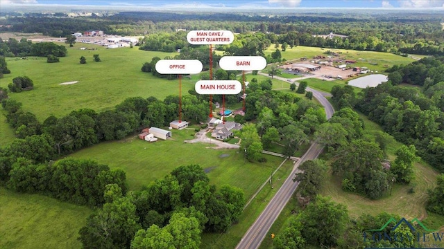 aerial view of property's location featuring a forest