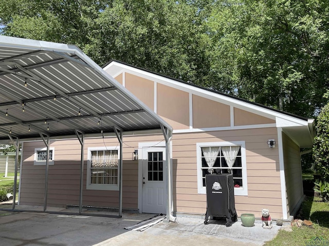 back of property featuring a detached carport