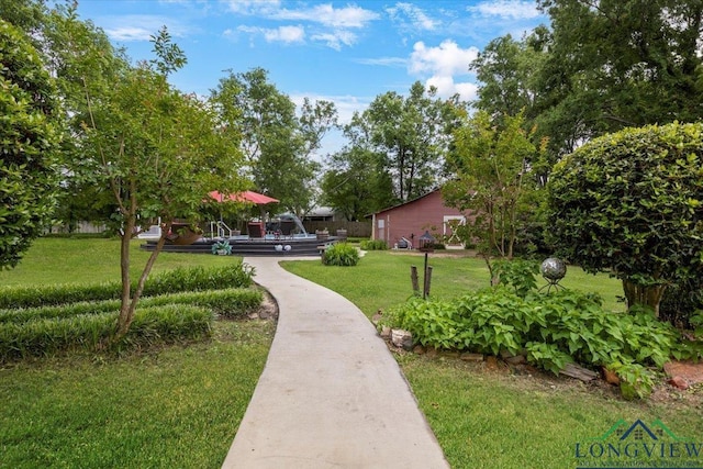 view of community with a yard and a wooden deck