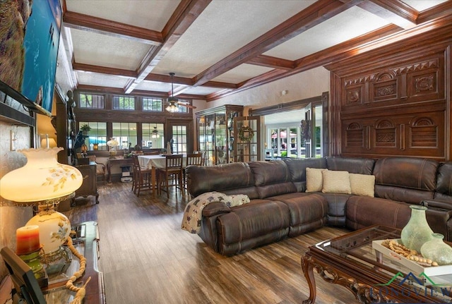 living room featuring coffered ceiling, beamed ceiling, wood finished floors, and crown molding