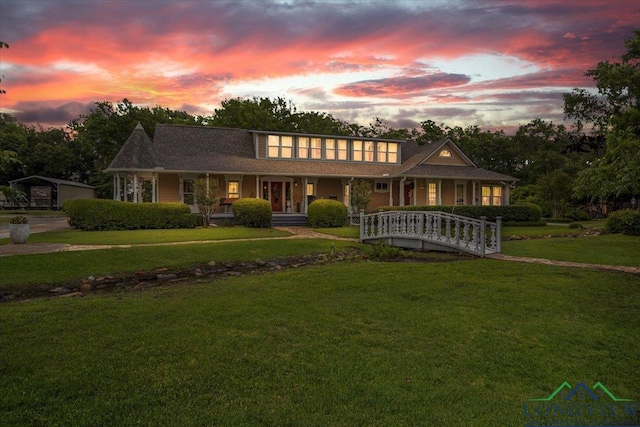 view of front of property with a porch and a front yard