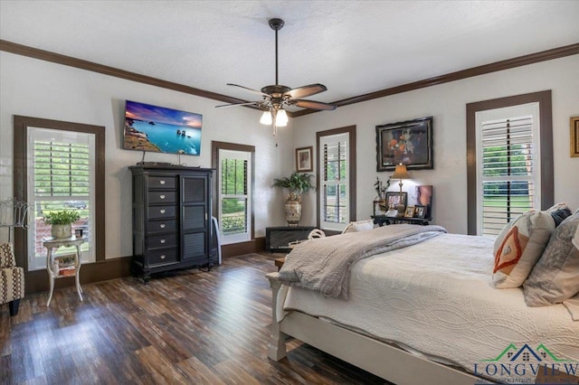 bedroom featuring dark wood finished floors, ornamental molding, a ceiling fan, and baseboards