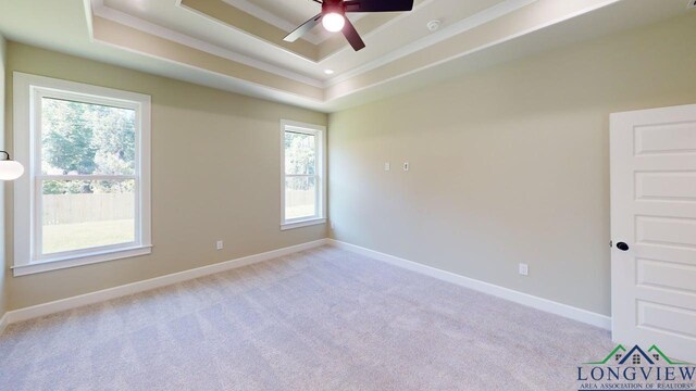 2510 Windmill Ln, Longview, TX 75601 - unfurnished room featuring a tray ceiling, a ceiling fan, baseboards, light colored carpet, and crown molding