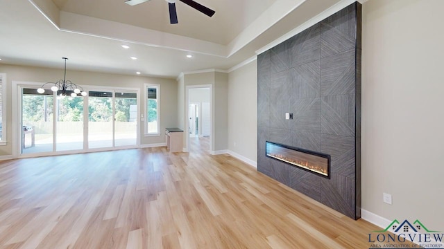 2510 Windmill Ln, Longview, TX 75601 - unfurnished living room with a ceiling fan, a fireplace, light wood-style floors, recessed lighting, and a chandelier