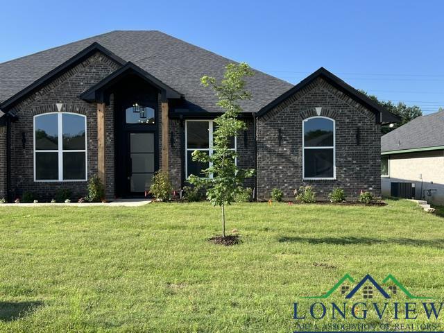 2510 Windmill Ln, Longview, TX 75601 - french country home with brick siding and a front lawn