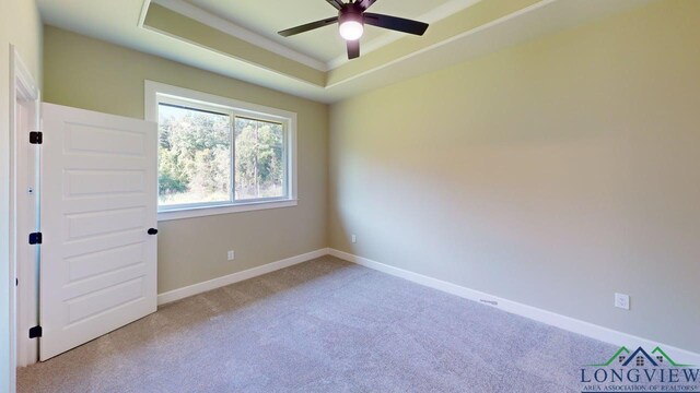 2510 Windmill Ln, Longview, TX 75601 - empty room with a raised ceiling, a ceiling fan, carpet flooring, and baseboards