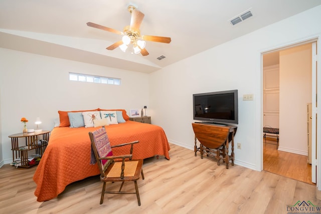 bedroom featuring light wood-type flooring, ceiling fan, and lofted ceiling