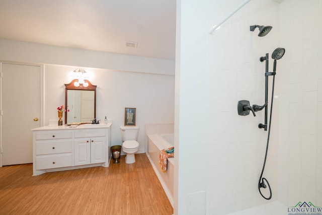 full bathroom featuring separate shower and tub, vanity, wood-type flooring, and toilet