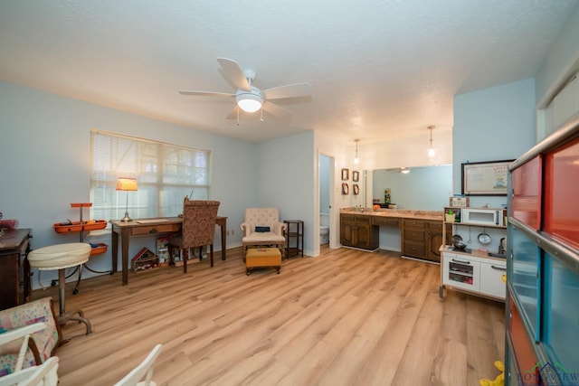 office area with light hardwood / wood-style flooring and ceiling fan