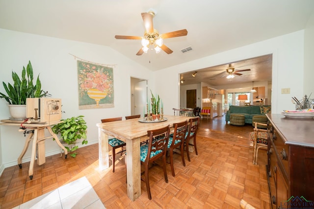 dining room with ceiling fan and light parquet floors