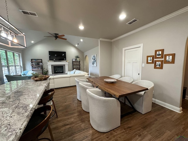 dining space with visible vents, a fireplace, dark wood-style floors, and ceiling fan