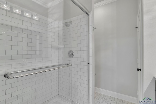 full bathroom featuring a shower stall, crown molding, baseboards, and tile patterned floors
