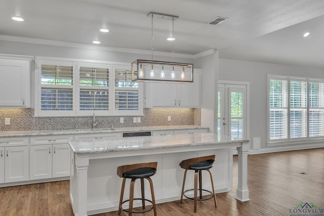 kitchen with visible vents, a sink, and white cabinetry