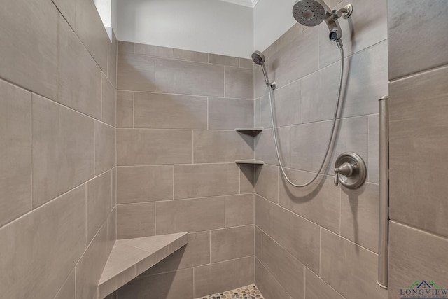 bathroom with a tile shower
