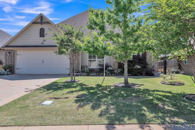 view of front of property with a garage, a front lawn, concrete driveway, and fence