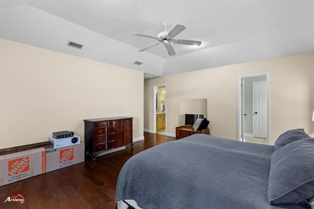 bedroom featuring ceiling fan, dark hardwood / wood-style flooring, connected bathroom, and vaulted ceiling