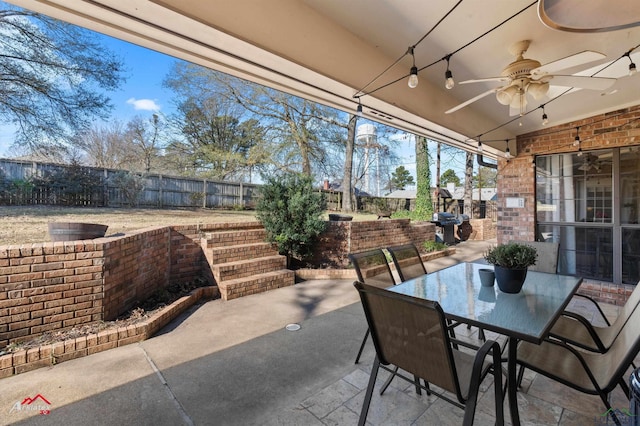 view of patio with ceiling fan and a grill