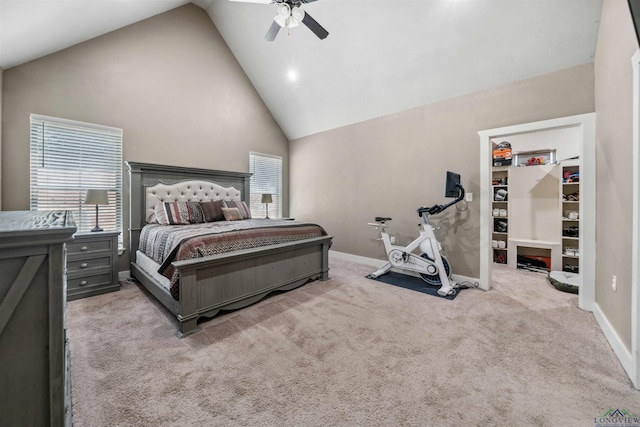 carpeted bedroom with multiple windows, ceiling fan, and high vaulted ceiling