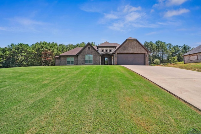 view of front facade with a garage and a front lawn