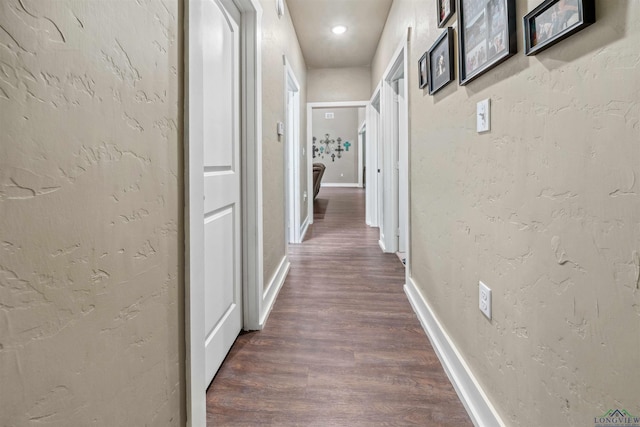 hallway with dark hardwood / wood-style floors