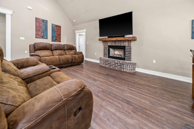 living room featuring high vaulted ceiling, a brick fireplace, and dark hardwood / wood-style floors