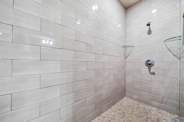 bathroom with a tile shower