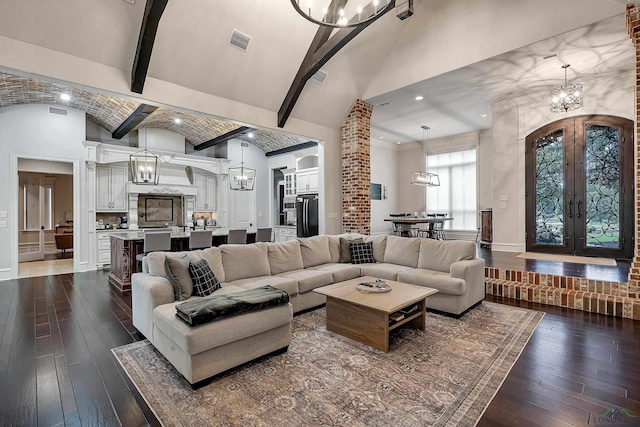 living room featuring beam ceiling, french doors, dark wood-type flooring, high vaulted ceiling, and brick ceiling