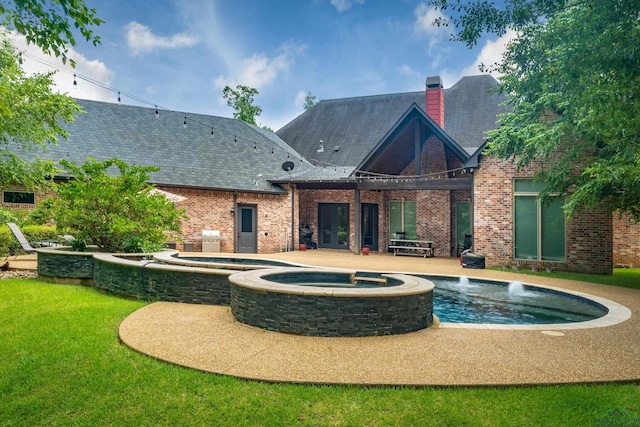 rear view of property featuring an in ground hot tub