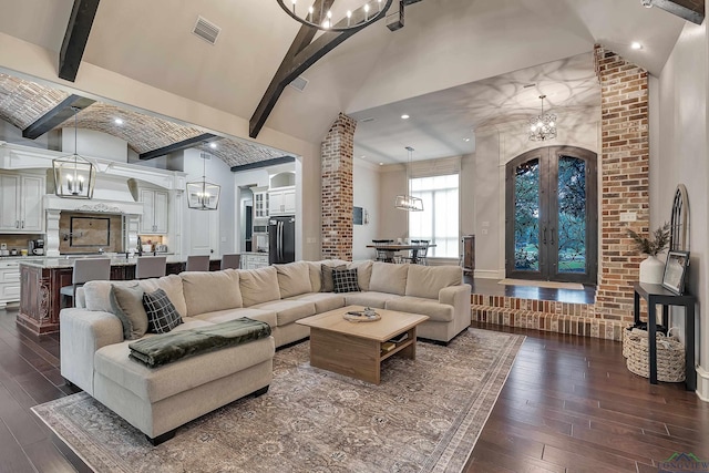 living room with beam ceiling, dark hardwood / wood-style flooring, high vaulted ceiling, and french doors