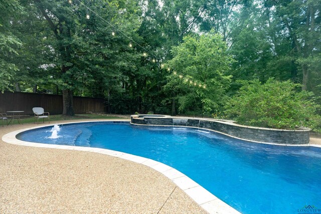 view of pool featuring an in ground hot tub