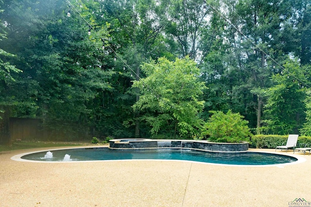 view of swimming pool with an in ground hot tub and a patio