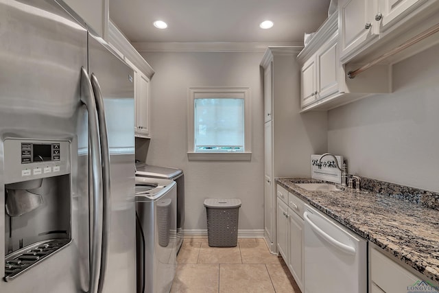 kitchen with dishwasher, washing machine and dryer, white cabinetry, and stainless steel refrigerator with ice dispenser