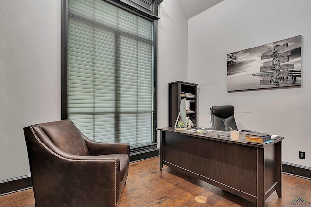 office area with dark hardwood / wood-style floors and vaulted ceiling