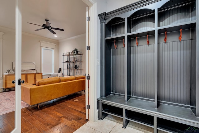 mudroom with wood-type flooring, ceiling fan, and crown molding