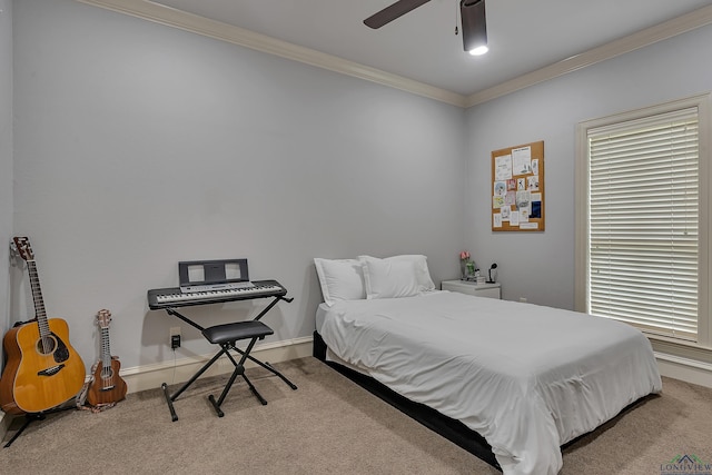 carpeted bedroom featuring ceiling fan and crown molding