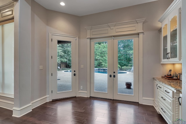 entryway with dark hardwood / wood-style flooring and french doors