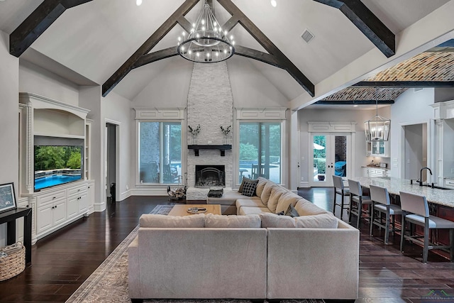 living room with a stone fireplace, french doors, high vaulted ceiling, and dark wood-type flooring