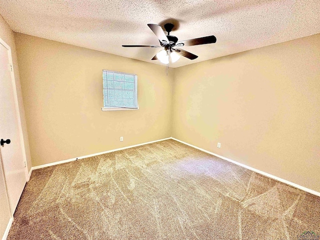 carpeted empty room featuring ceiling fan and a textured ceiling