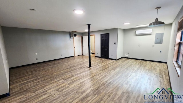 4350 Fm 1650, Gilmer, TX 75645 - below grade area with a wall mounted AC, wood finished floors, and electric panel