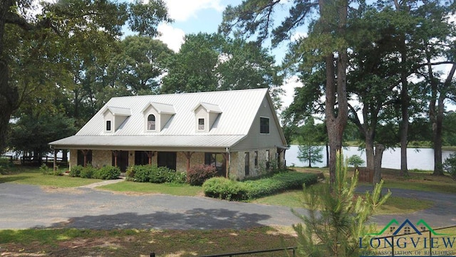 4350 Fm 1650, Gilmer, TX 75645 - view of front facade with a metal roof, covered porch, and stone siding